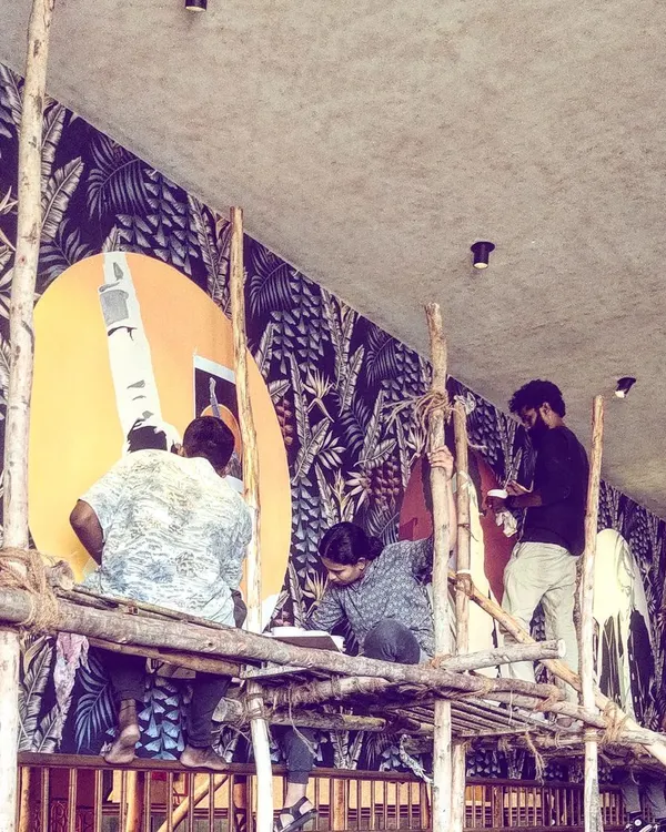 The team high up on scaffolding, working on a massive tropical-themed mural. This shot captures the scale of our projects and the collaborative effort required to bring these huge walls to life.
