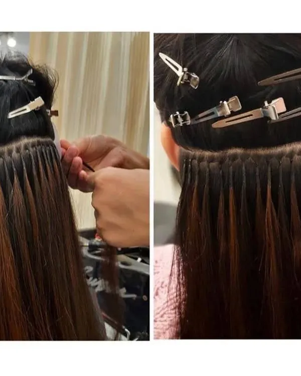 This is a close-up of the meticulous process for applying permanent extensions. Each strand is carefully bonded to create a look that is secure, comfortable, and completely natural.