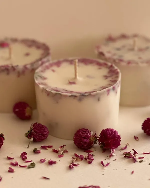 This is a detailed look at my custom botanical pillar candles. Made with high-quality wax and infused with dried rose petals, these candles are as beautiful as they are fragrant. They are a popular choice for spa-themed gift boxes and home decor enthusiasts.