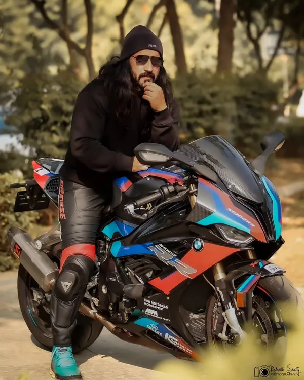 A powerful portrait of a rider with his BMW superbike. The low angle and the model's intense gaze create a look that is all about beauty and beast.