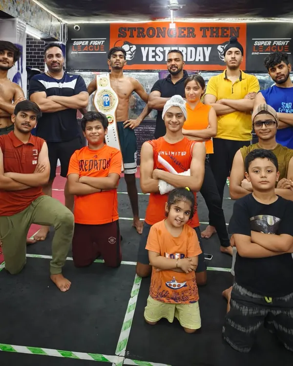 Attitude is in our blood. The team posing at our gym in Tagore Garden, with fighters of all ages, including a Super Fight League champion.