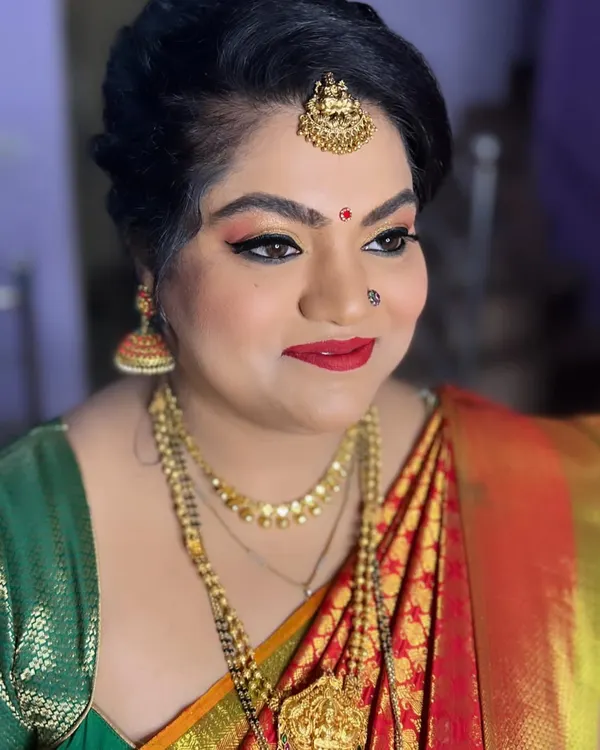 This client's only request for her daughter's naming ceremony was glittery eyes, and I was happy to deliver. This bold look features gold glitter, winged liner, and a classic red lip.