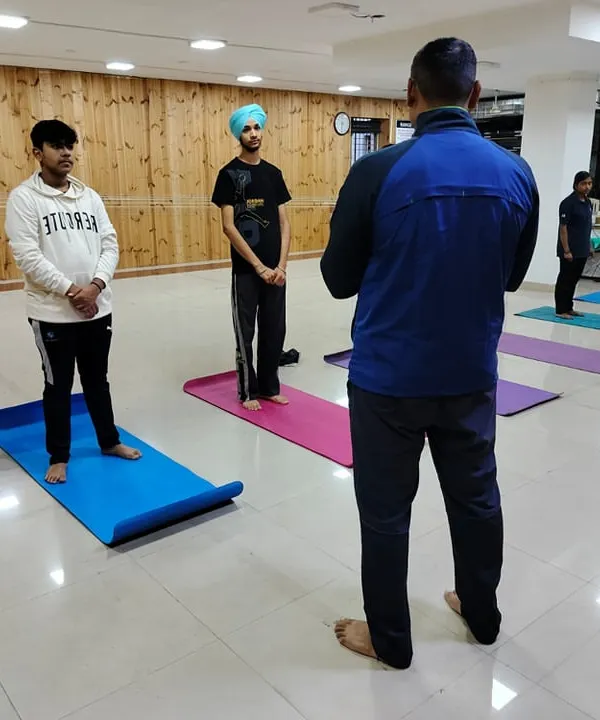 Our coach leading a yoga and stretching session for our shooters. These exercises are crucial for developing the mental and physical fortitude required in competitive shooting.