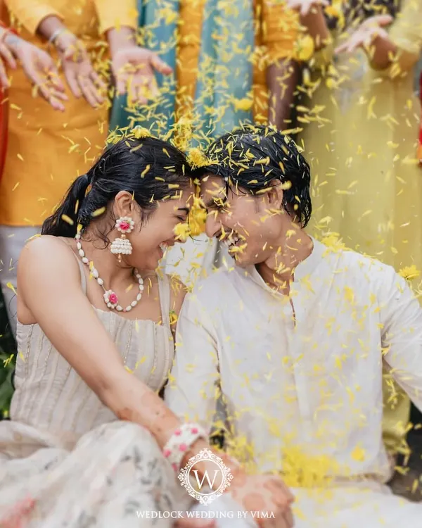 A moment of pure joy and laughter during a Haldi ceremony. We created a backdrop of vibrant yellow florals and rustic cane baskets to create a space that felt like basking in sunshine.