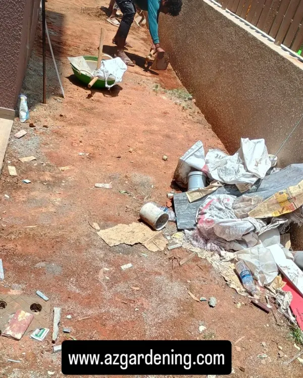 The first step in any installation is a thorough site clearing. Here, my team is removing all debris and old construction materials from a side yard.