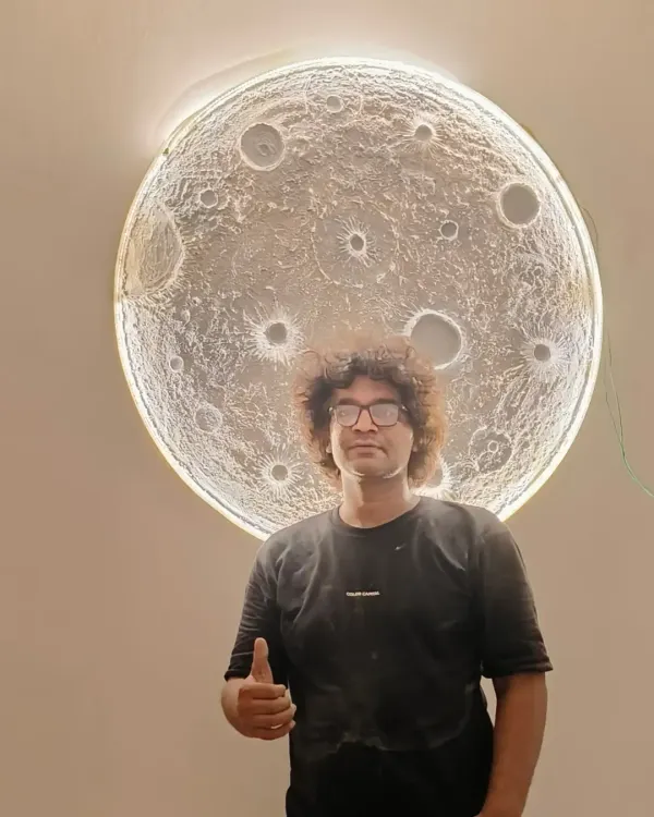 Here I am with one of my proudest creations, the 3D textured moon art. This piece is large enough to be a major feature in any room and has a backlight that gives it an incredible, realistic glow.