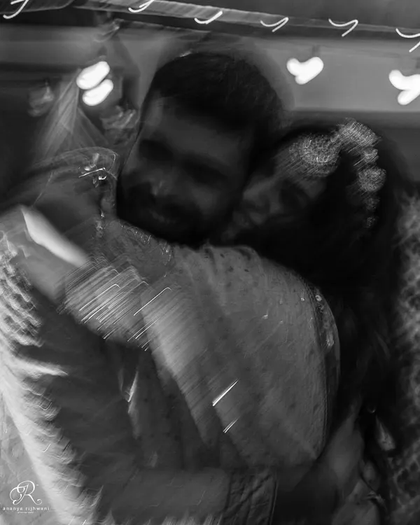 This blurry, black and white hug is one of my signature styles. It’s an abstract way to represent a powerful emotion, focusing on the feeling of the embrace rather than the details. It’s a perfect example of capturing real moments over poses.