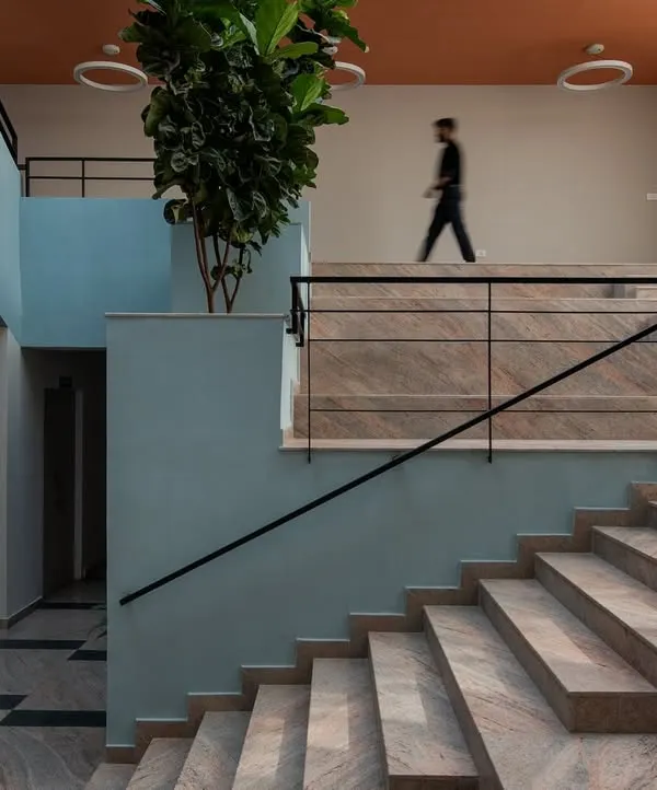 The main staircase of the Nirbhaya Centre in Bangalore, a government facility for women and children. We used wide, welcoming steps, soothing colors, and indoor planters to create a space that feels safe, approachable, and non-institutional.