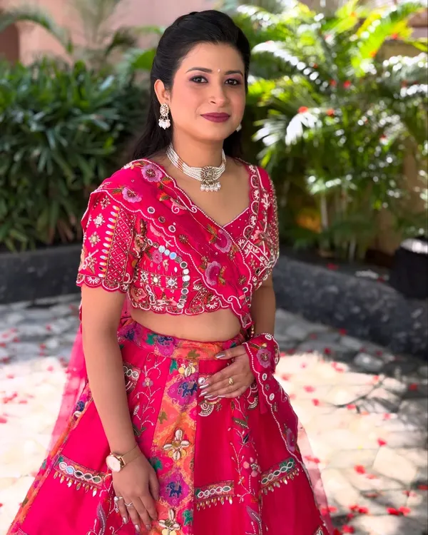 A full-length view of the soft glam look, showing how the makeup complements the vibrant pink floral lehenga, making it perfect for a day wedding or party.