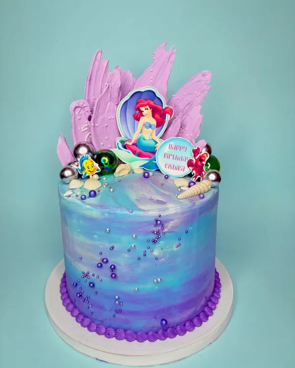 We had so much fun bringing this Little Mermaid cake to life. The underwater-themed buttercream, chocolate sails, and Ariel topper create a magical scene perfect for a Disney fan's birthday.