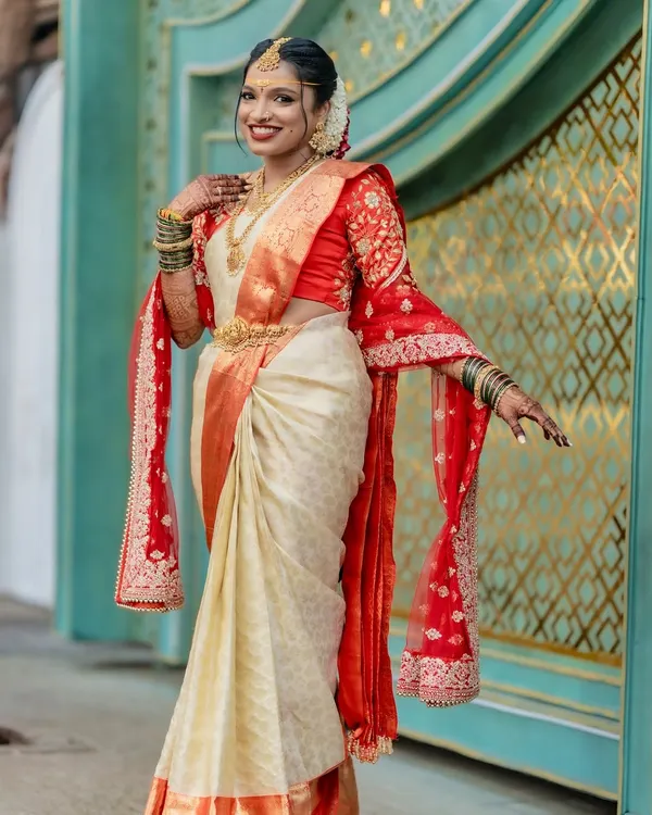 This is the result we aim for with every saree: a radiant bride feeling confident and beautiful on her wedding day. We pre-pleated this traditional off-white and red silk saree to create a flawless drape that lasted through all the ceremonies.