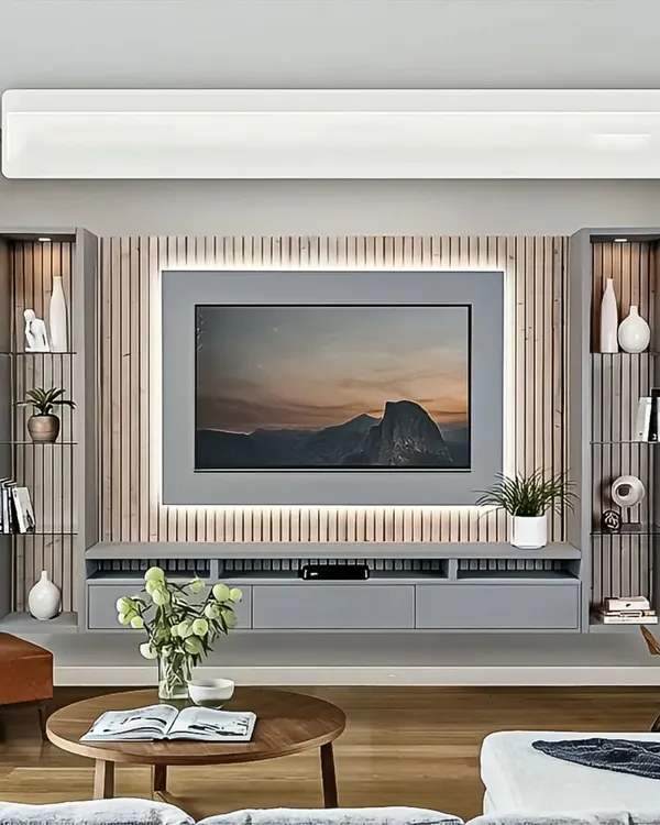 A sleek, floating entertainment unit in a calming grey finish. The design features a fluted wood panel backdrop with integrated LED lighting, creating a sophisticated and modern focal point for the living room.