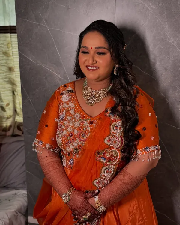 The special glow of a mom-to-be. For her baby shower, we created a soft and radiant makeup look to match her vibrant orange outfit.