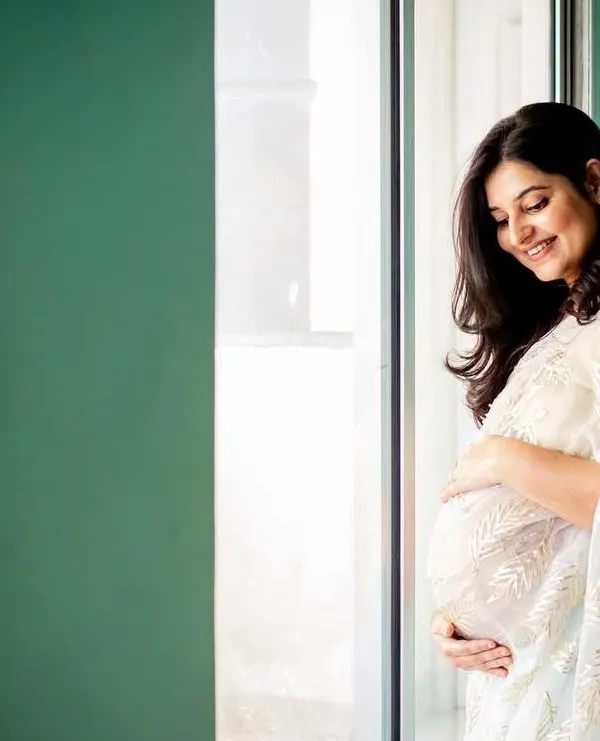 I love how the soft window light illuminates this mama-to-be. Dressed in a beautiful white sari, this solo maternity portrait is the definition of grace and elegance.