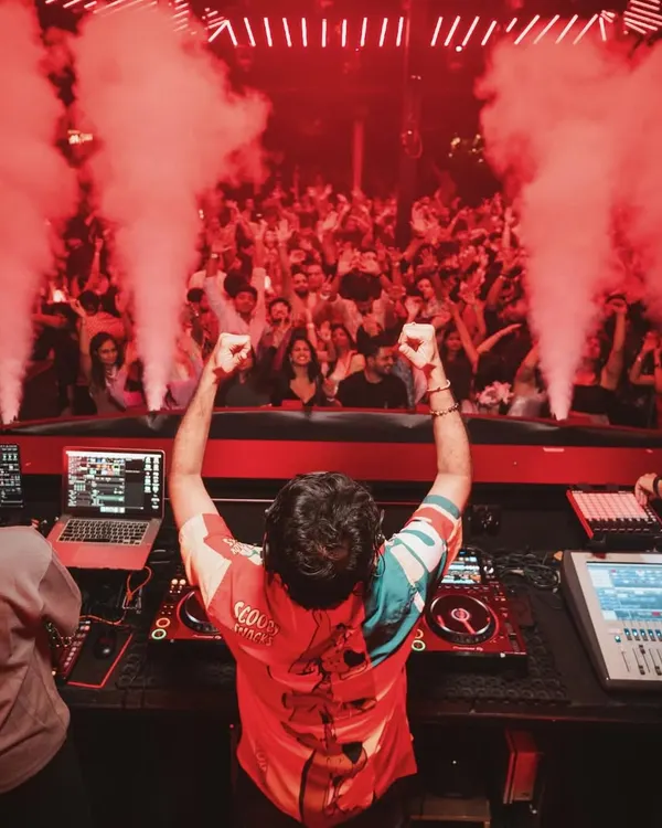 This is what it looks like from my perspective at a packed club in Goa. The energy is electric, with smoke cannons firing over the crowd.