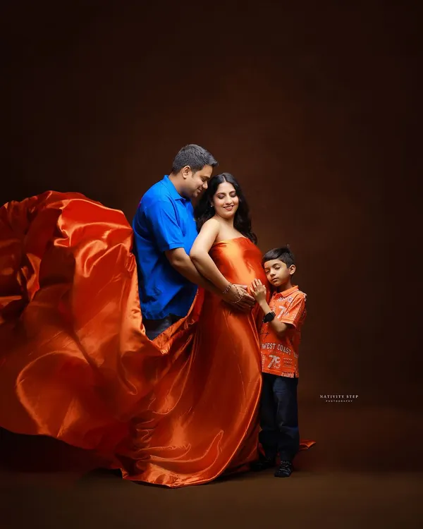 A beautiful family portrait, including the older sibling. It's so special to capture the excitement of a big brother or sister as they wait for the new baby.