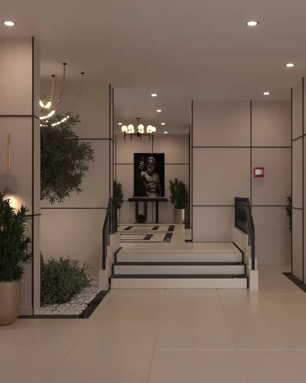 A view of the lobby showing the blend of modern paneling, greenery, and classical art. The mirror reflects the elegant chandelier, adding depth to the space.