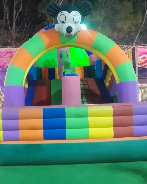 A classic Mickey Mouse themed bouncy castle, perfect for a child's birthday party. This inflatable includes a small slide and jumping area, ensuring hours of fun in a compact space.