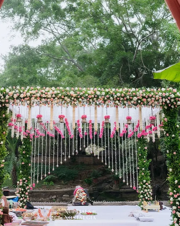 A breathtaking floral mandap at our Pond Pavilion, with cascading flower strings creating a dreamy backdrop for the wedding ceremony.
