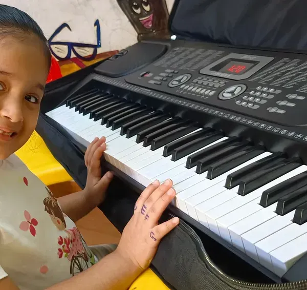 That smile is our biggest reward. We aim to make every music class a happy experience, helping young learners like this student build confidence at the piano.