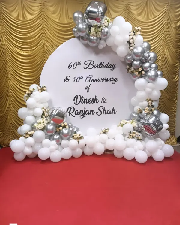 A special backdrop for a double celebration: a 60th birthday and a 40th anniversary. I used a classic white and silver balloon arch with the couple's names, Dinesh and Ranjan Shah.