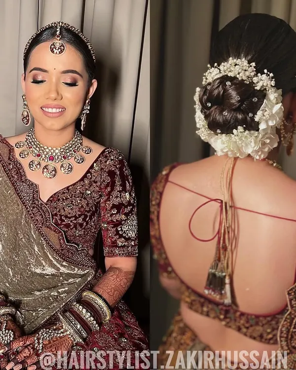 A classic bridal bun is elevated with a full garland of fresh white flowers and baby's breath. This sleek and polished updo is perfect for securing a dupatta and ensuring the bride looks flawless throughout the ceremony.