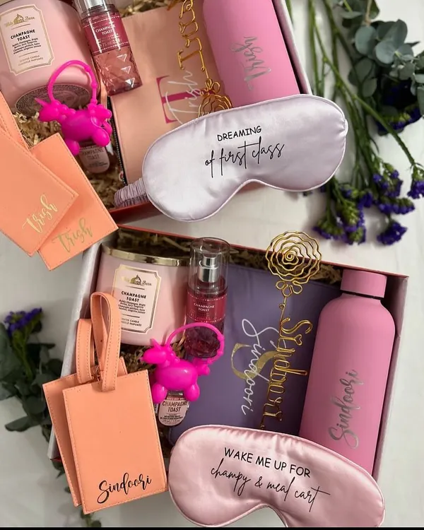 A beautiful bridesmaid hamper filled with personalised travel essentials. This set includes custom luggage tags, a water bottle, a scented candle, and a pretty eye mask, perfect for a destination wedding.