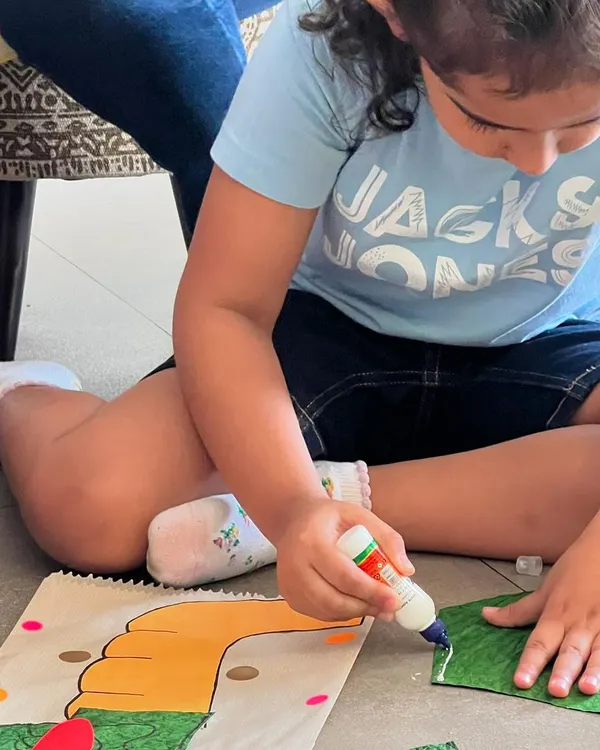 Concentration and creativity in action. This little girl is carefully crafting her own dragon paper bag puppet after watching my show. It's a wonderful, quiet activity after the excitement of the story.