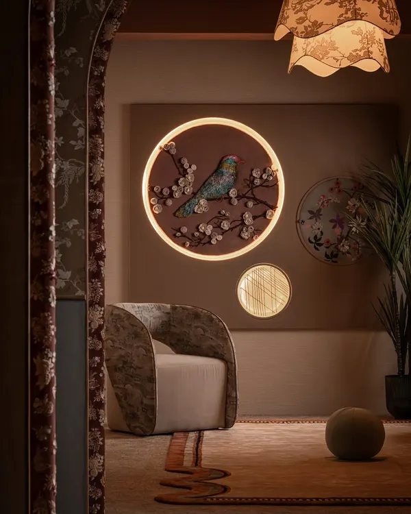 This is Zone One, the quiet invitation into the world of Moire. We designed this space to feel warm and layered, with a custom fabric mural featuring an embossed bird, a sculptural armchair, and a bespoke rug that together set a thoughtful, personal tone.