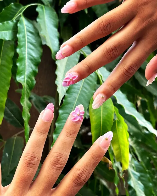 Perfect for summer, this set features beautiful 3D sculpted pink flowers on long, almond-shaped extensions. The design is complemented by a pink plaid pattern and gold bead accents.