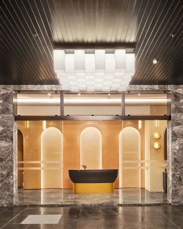 This is where the magic begins. I believe a venue's entrance should do more than just welcome guests; it should set the tone for the entire experience. Here, a combination of dramatic lighting, rich marble, and grand architectural arches creates a sense of arrival and anticipation for the celebration inside.