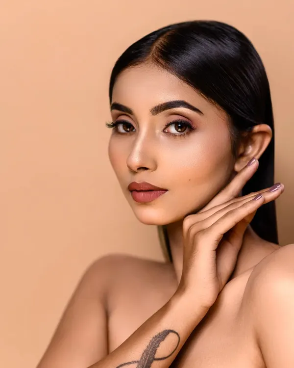 This is a classic beauty shot with clean, soft lighting against a neutral background. The focus is entirely on the model's flawless skin and the subtle, elegant makeup, showcasing my high-end retouching skills.