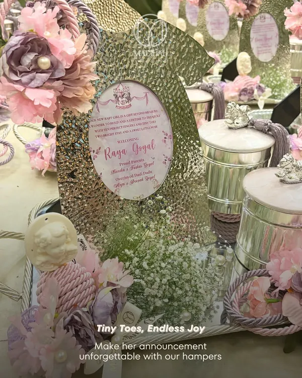 "Tiny Toes, Endless Joy." Our baby announcement hampers are designed to make the announcement unforgettable. This one features a silver-plated tray, a hammered photo frame, and keepsake jars in a lovely lavender and silver theme.