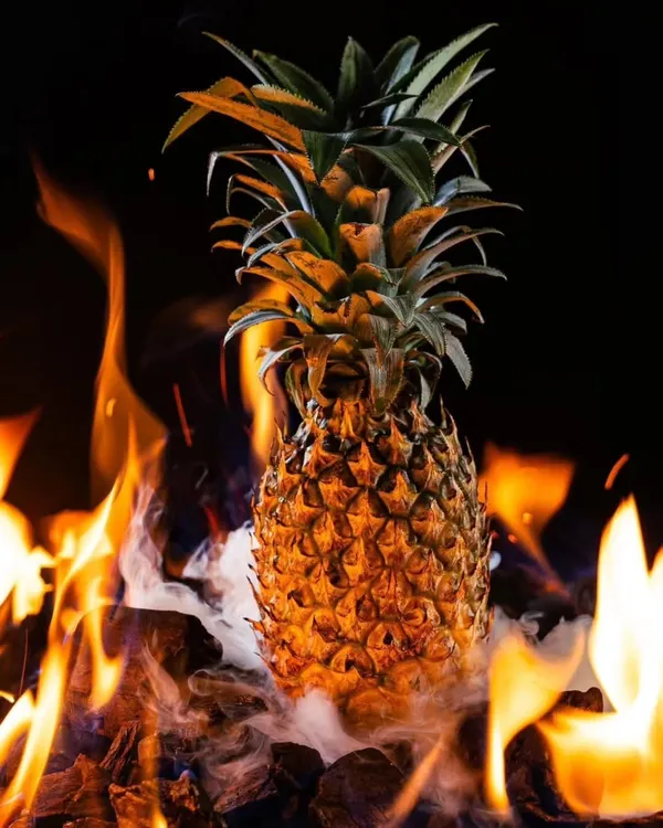 The start of our fiery shoot for Hundo Pizza. We used a real pineapple set on burning coals to create a dramatic and elemental image that ties into their brand's edgy theme.