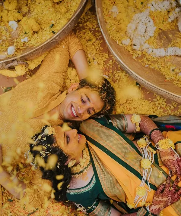 This is the kind of magic we live to capture. A moment of pure, uninhibited joy after a Haldi ceremony, where the couple is lost in their own world, surrounded by a shower of flower petals. This award-winning photograph represents everything we love about candid wedding photography.