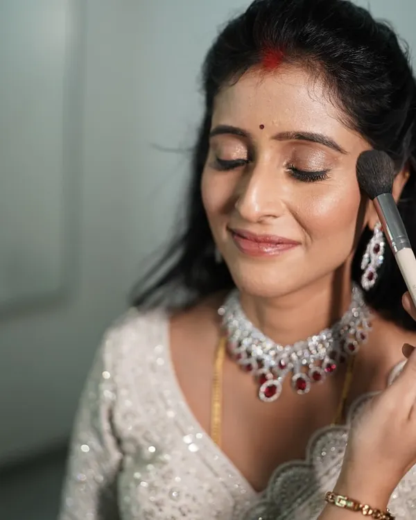 I believe in using the best products to achieve a natural, skin-like finish. Here is a glimpse of me giving the final touches to a bride's makeup.