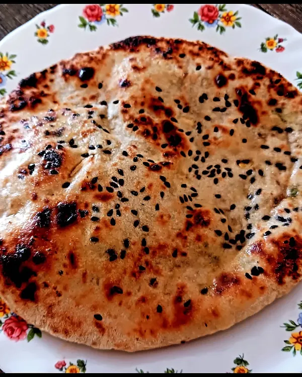 A fluffy, perfectly charred millet naan stuffed with savory tofu. Learning to make gluten-free breads that are soft and delicious is one of the most rewarding skills I teach.