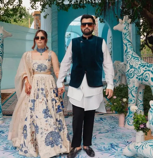 A couture-inspired Mehendi where the decor is as stylish as the couple. The backdrop features custom animal sculptures painted with blue Dior-esque patterns, creating a whimsical yet high-fashion photo opportunity.