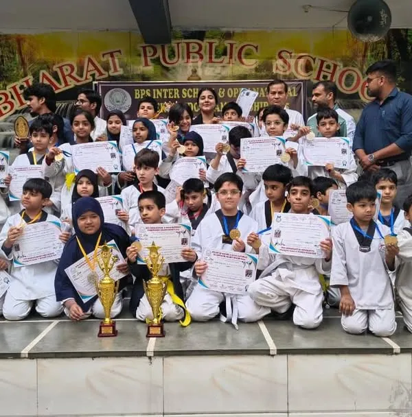 Our team of champions from Strike International Taekwondo Academy posing with their well-earned trophies and certificates after a successful tournament.