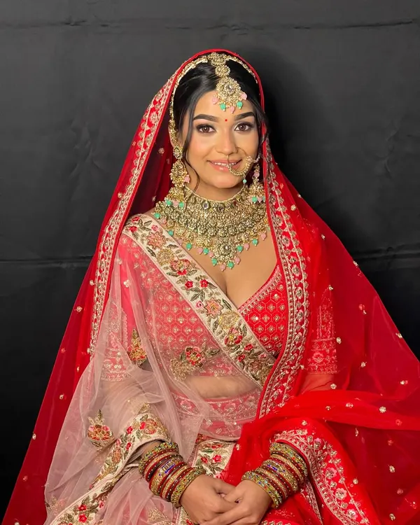 This classic red bridal lehenga is what dreams are made of. The intricate embroidery and rich color make it perfect for a traditional wedding ceremony, ensuring you look and feel like royalty on your big day.