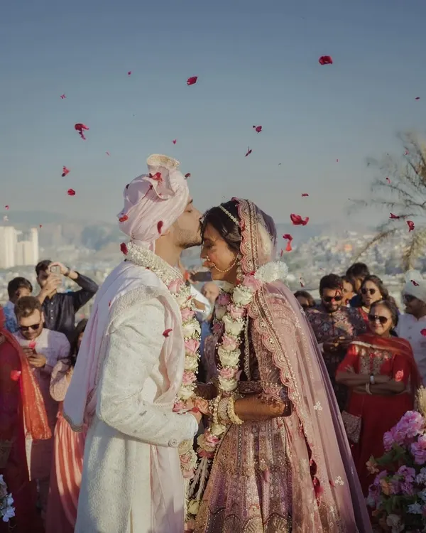 This is the moment. The world fades away, and all that's left is the promise of forever. I strive to create the perfect setting for these priceless memories, where every detail, like the shower of petals, adds to the magic of your love story.