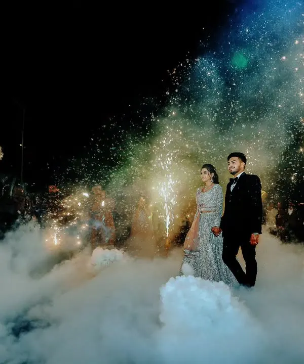 A grand entrance for the couple at their reception, walking through a cloud of low fog and sparkling pyrotechnics. This is how we create magical, cinematic moments.