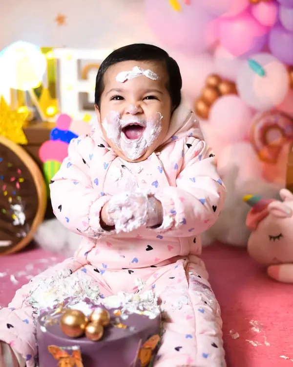 The best part of turning one is getting your hands messy! This little one is having the time of her life during her donut and candy themed cake smash session.