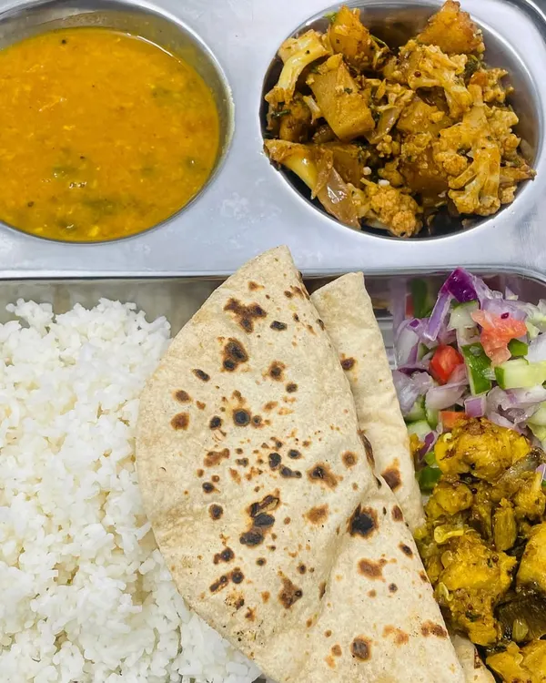 Our standard roti and rice meal. This thali comes with soft rotis, steamed rice, flavorful dal, aloo gobi sabzi, and a side of our special fried snack and fresh salad.