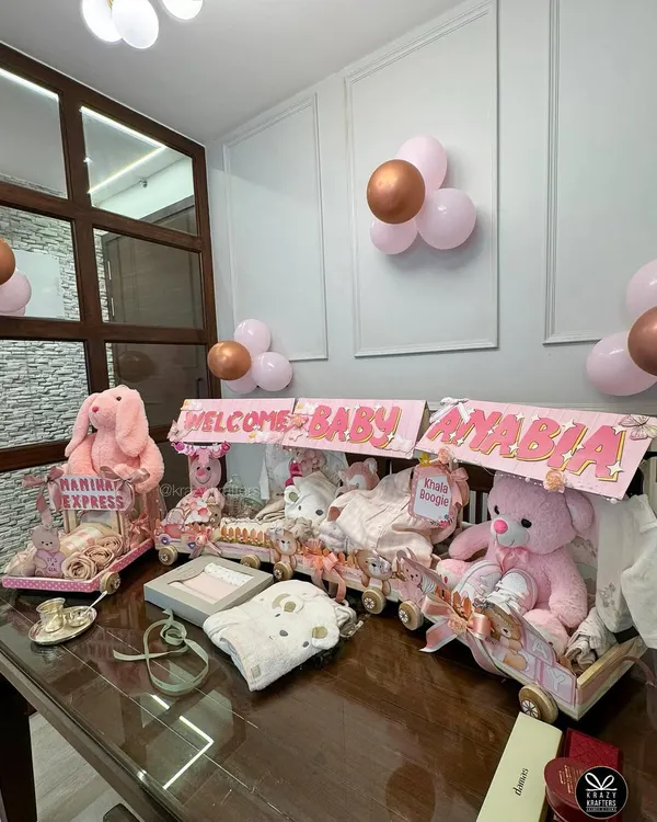 A full view of the 'Nanihaal Express', a custom baby trousseau train I designed to welcome a newborn girl. Each carriage is filled with gifts, clothes, and toys, creating an unforgettable welcome home display.