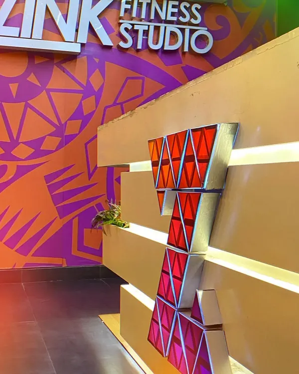 A close-up of our reception desk and the vibrant, custom-designed wall art that welcomes you into the studio.