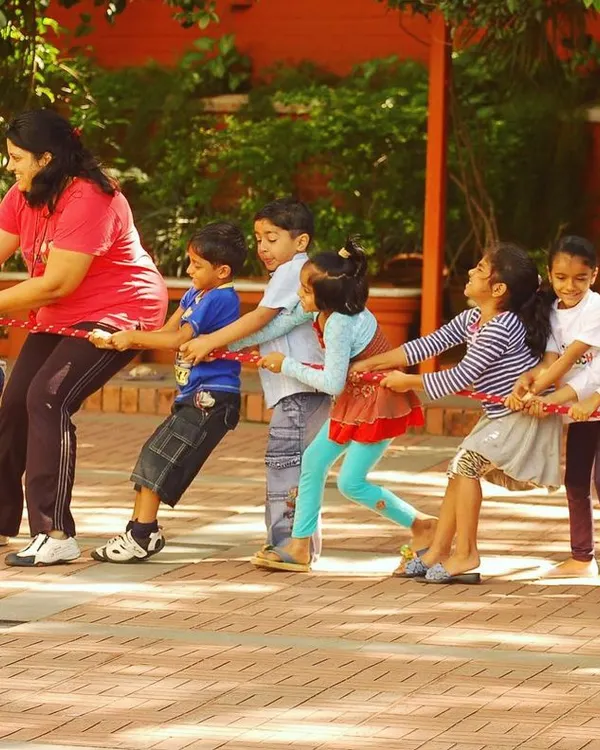 An instructor joins in on the Tug of War fun, encouraging the children and demonstrating the power of pulling together as a team.