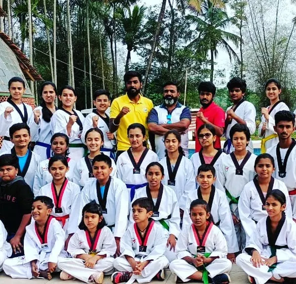 We believe in building a strong community. Here is our entire team, with students from different age groups and belt levels, during a special taekwondo training camp.