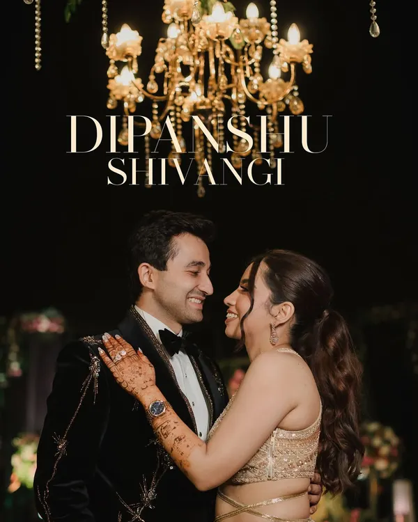 A romantic portrait of the couple sharing a smile under a grand golden chandelier. This shot captures the elegance of their sangeet night, highlighting their chemistry and the luxurious ambiance.
