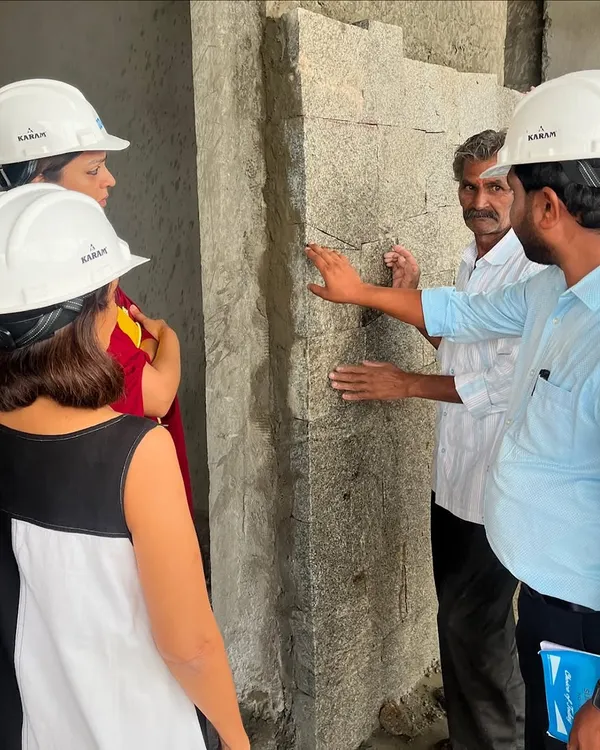 Our process is an orchestra of decisions. Here, our team is on-site, discussing the texture and finish of a stone wall with the masons, ensuring every detail aligns with our design intent.